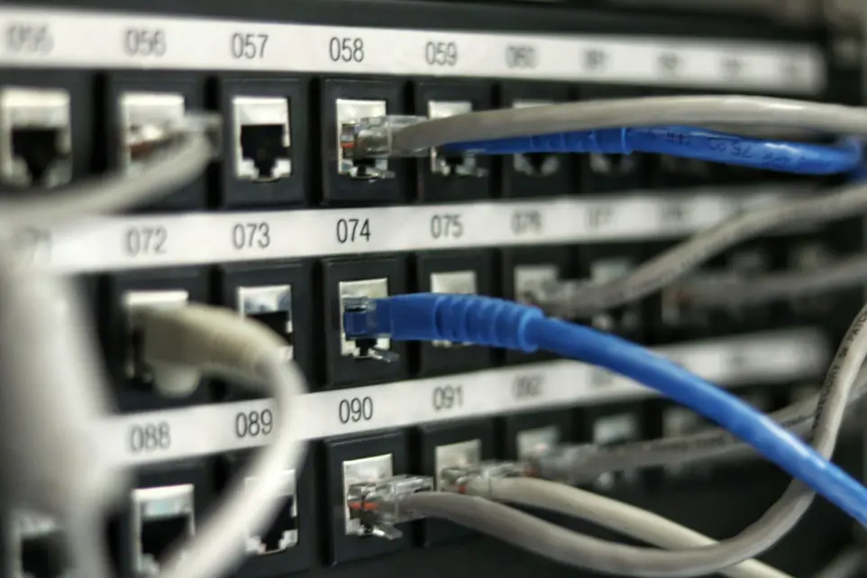 Blue network UTP cable connected to a switch, symbolizing NNOCONN infrastructure solutions