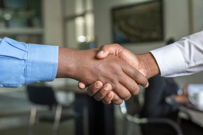 Business partners shaking hands, symbolizing NNOCONN commitment and client partnership